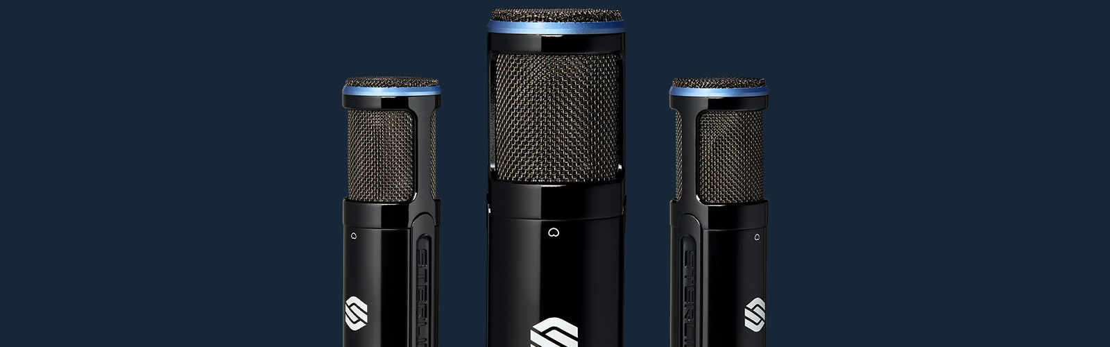3 Sterling SP150SMK studio condenser microphones on blue background.
