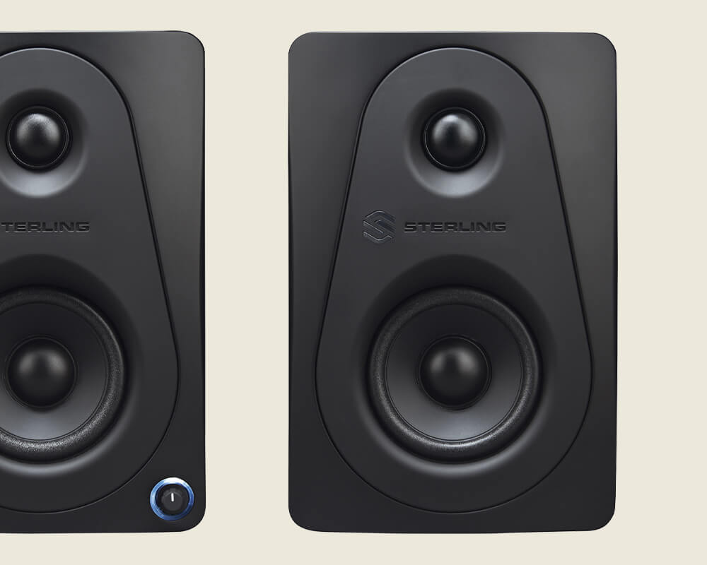 Sterling Audio MX3 3-inch powered studio monitor pair front on light background.