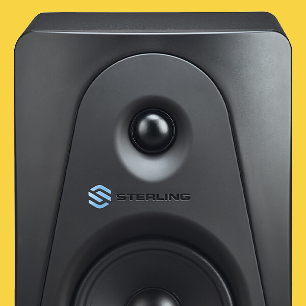 Sterling Audio MX3 3-inch powered studio monitor front top on yellow background.