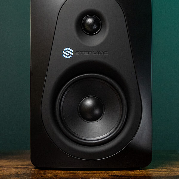 Sterling MX8 8-inch powered studio monitor front on home studio desk.