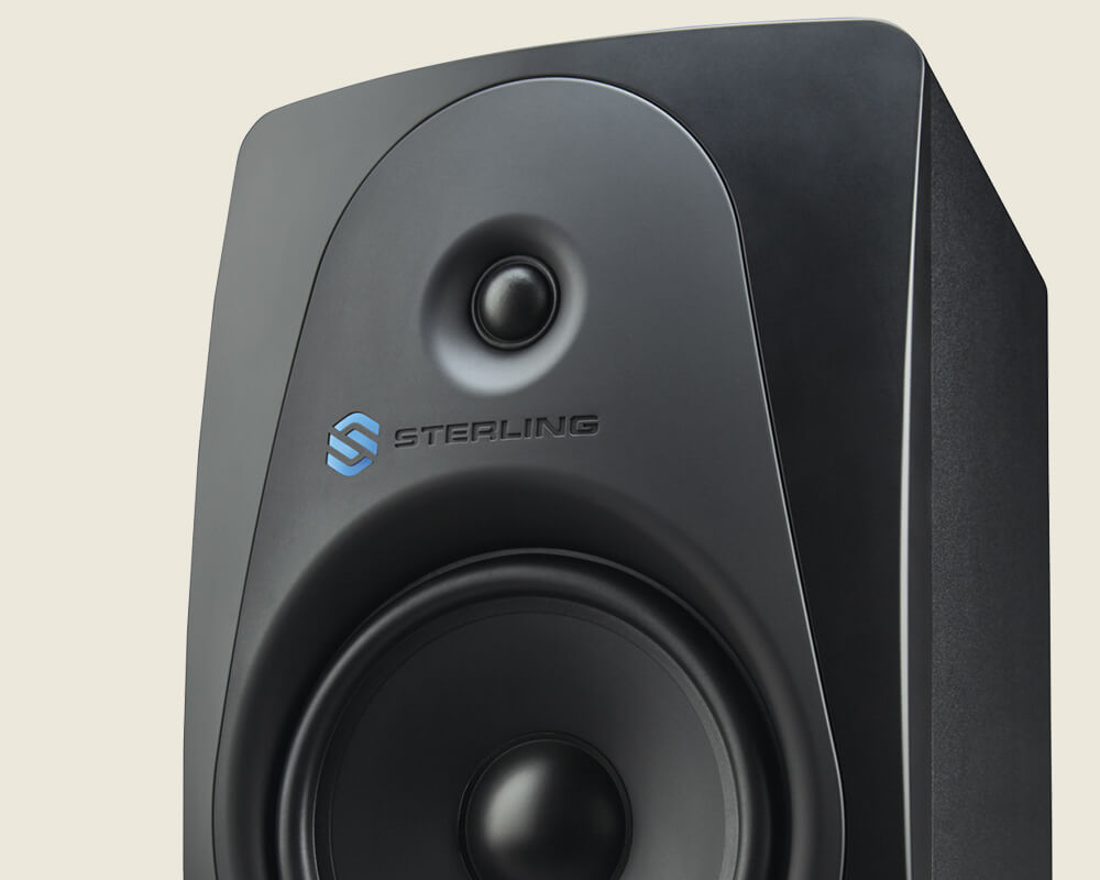 Sterling MX8 8-inch powered studio monitor left on light background.