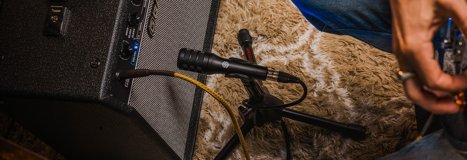 Sterling P10 instrument microphone in studio with amplifier and guitarist.