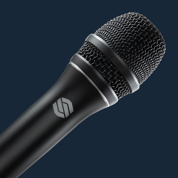 Sterling P30 active dynamic vocal microphone angled close up on blue background.