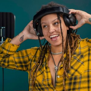 Sterling Audio S400 studio headphones on happy woman head.