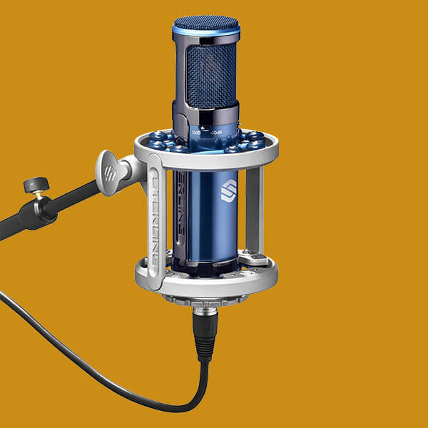 Sterling ST169 multi pattern tube condenser microphone shock mounted on yellow background.
