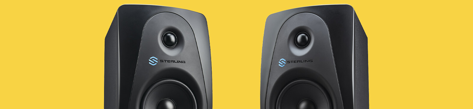 Sterling MX5 5-inch powered studio monitor right and left on wide yellow background.