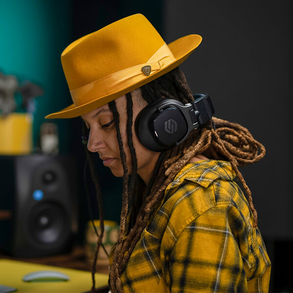 A woman listening to Sterling S400 studio headphone.