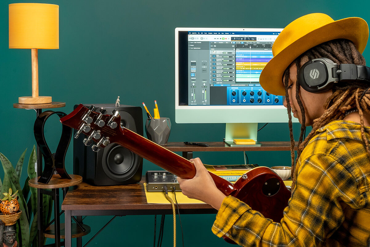 An artist in a studio using Sterling Audio Harmony H224 audio interface.