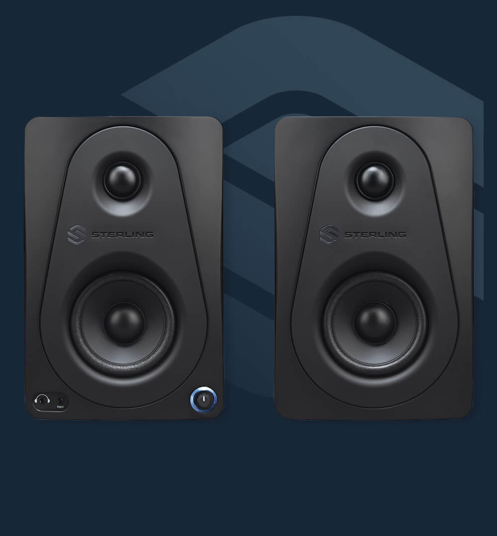 Sterling MX3 3-inch powered studio monitor pair front on blue background.