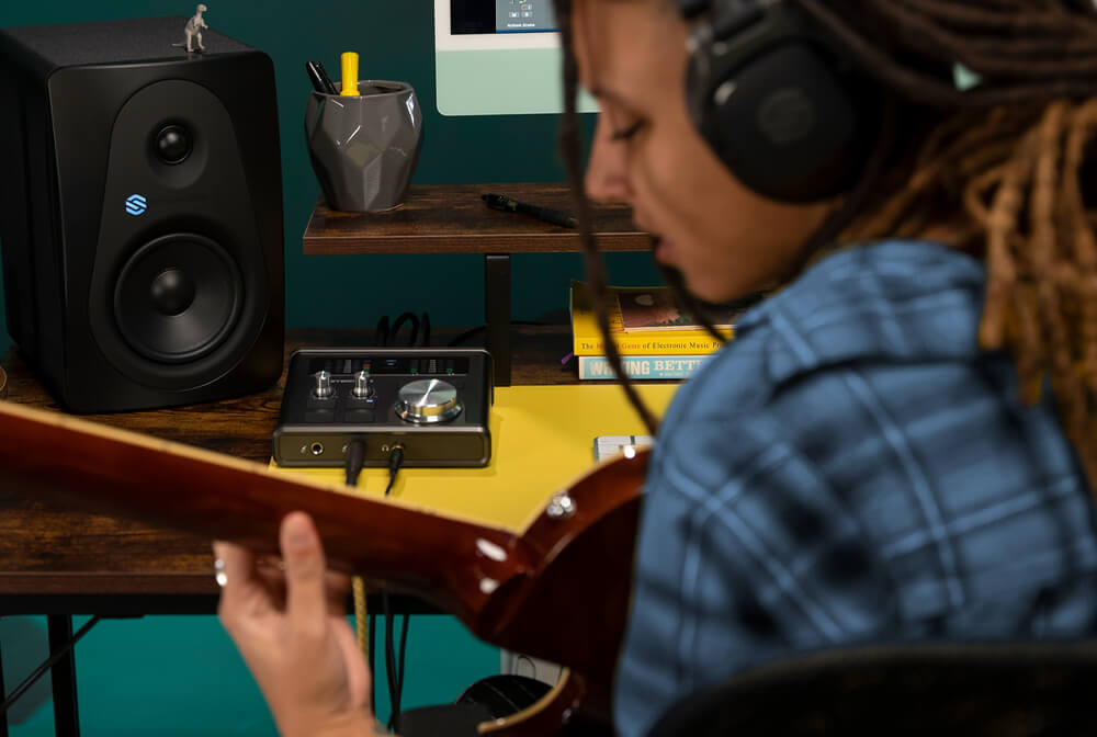 A woman using Sterling Harmony H224 audio interface.