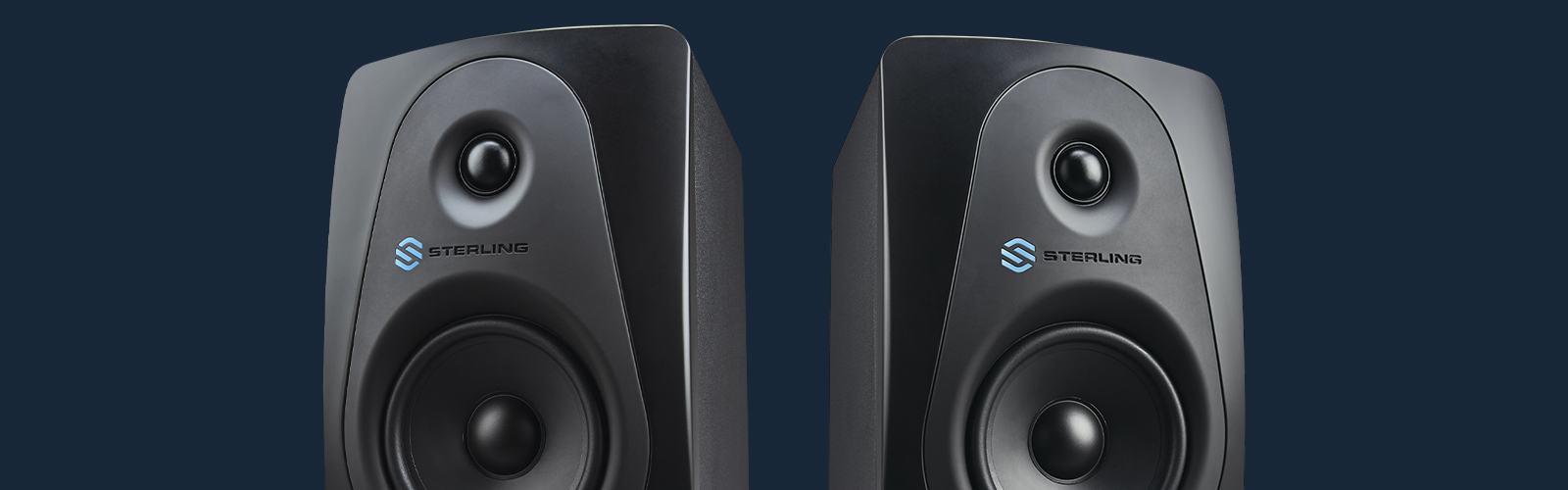 Sterling MX5 5-inch powered studio monitors pair on blue background.