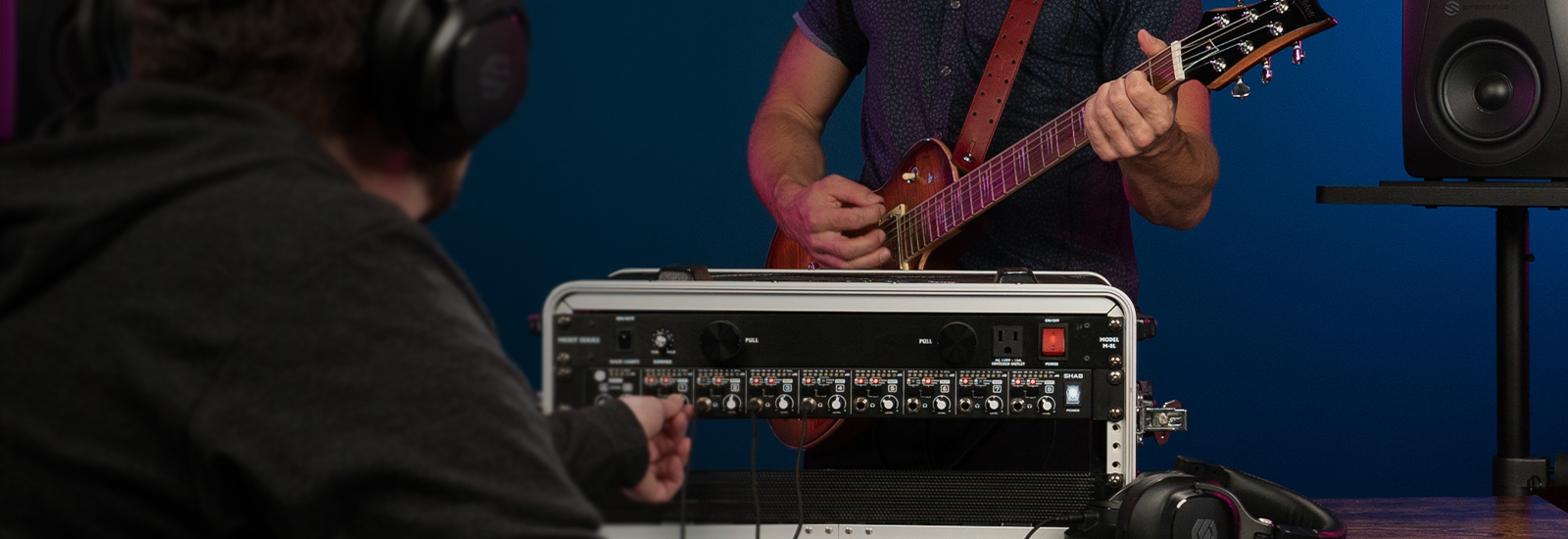 Sterling SHA8 8-channel rackmount headphone amplifier being setup in a studio with guitar player.