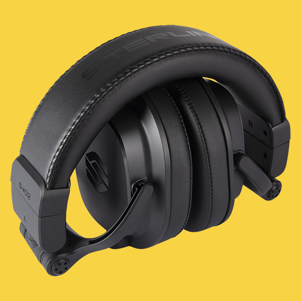 Sterling Audio S402 studio headphone folded on yellow background.